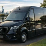 Black luxury van by waterfront.